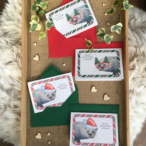 Pack of 4 otter Christmas cards have an otterly brilliant Christmas funny illustrated printed cards with red and green envelopes